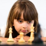 Young girl playing chess